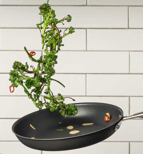 Broccolini tossed in nonstick skillet with garlic and red chili