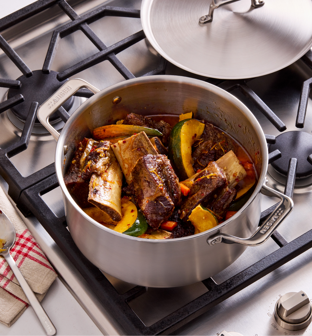 Braised beef short ribs with vegetables in Misen stainless steel pot on gas stove